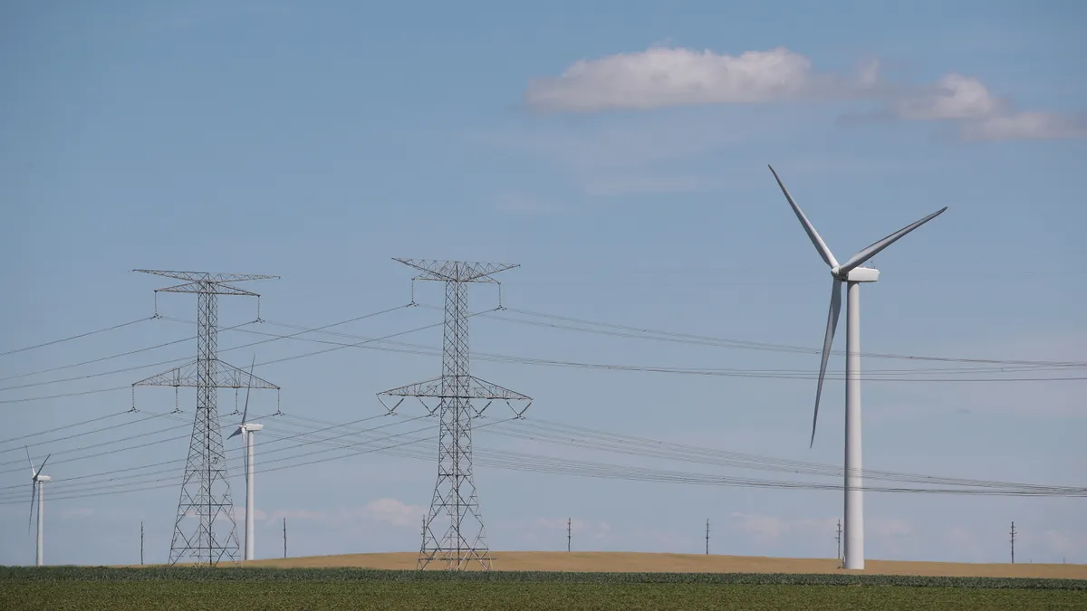 Power lines and power generating windmills rise above the rural landscape in Illinois.