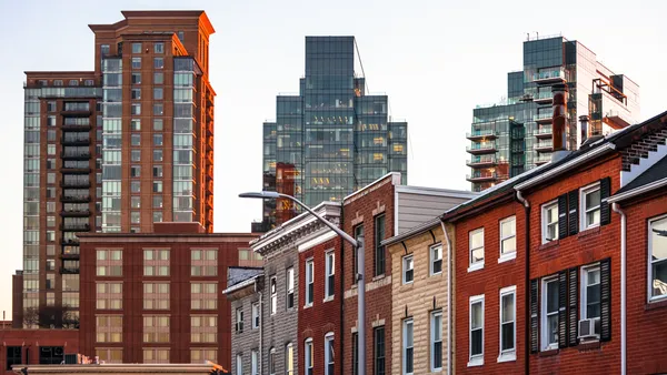 Row houses with skyscrapers in the background