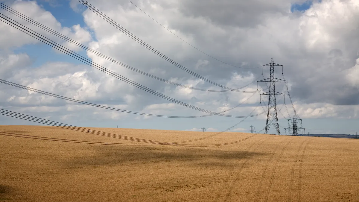 Empty grasslands with electrical towers running through it