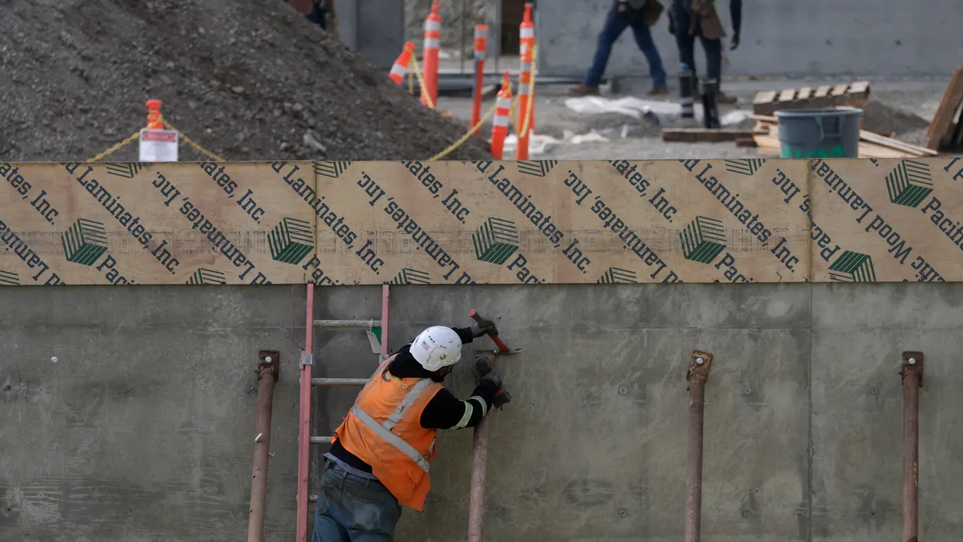 Construction workers build out a new building in San Francisco, California