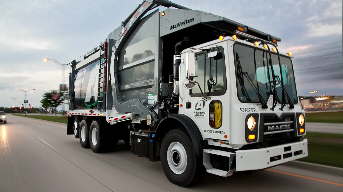 Advanced Disposal Services truck driving at sunset