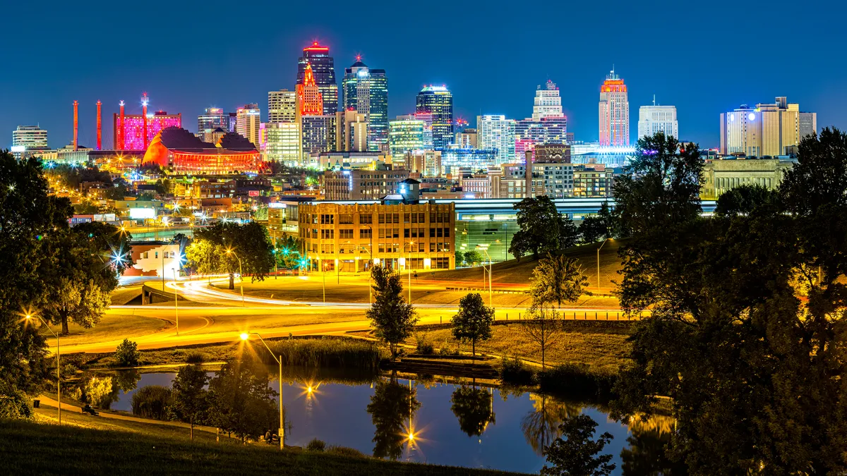 The bright lights of a city skyline captured at night.