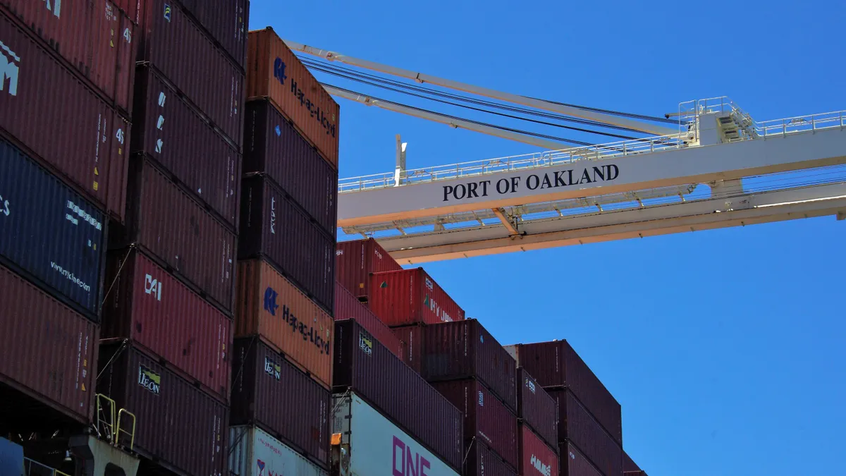 Ocean containers stacked on a vessel at a water port.