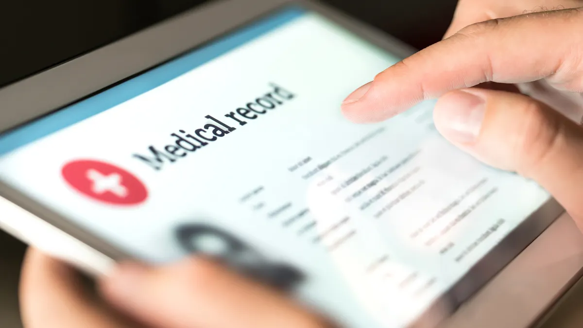 Person typing a medical record on an ipad