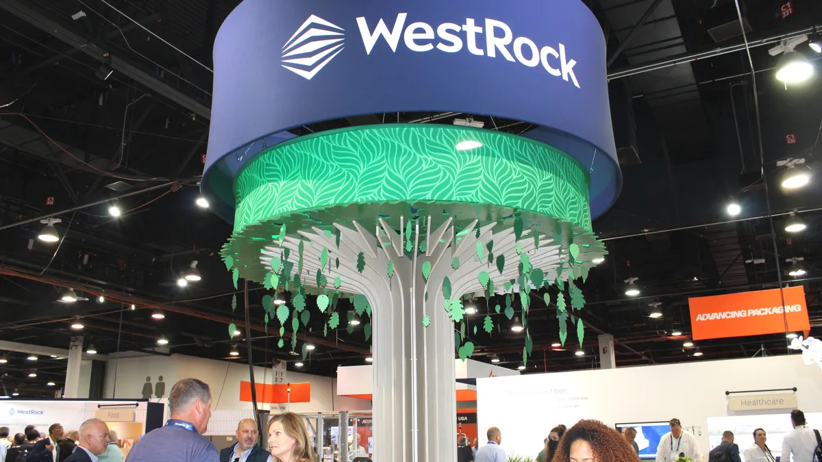 WestRock's booth display at Pack Expo featuring a green tree and blue background.