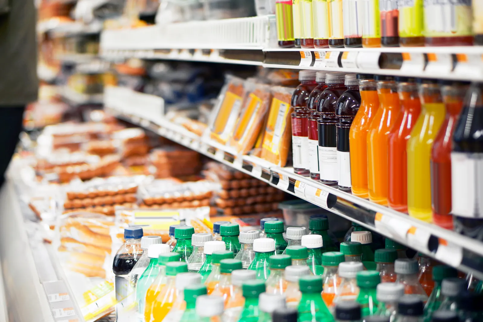 Packaged items on refrigerated grocery shelves.