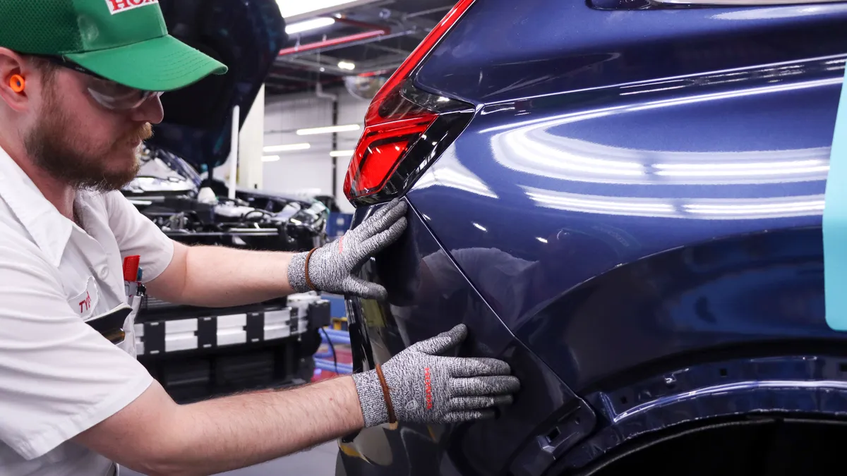 A Honda associate does a quality check on a 2023 Honda CR-V.