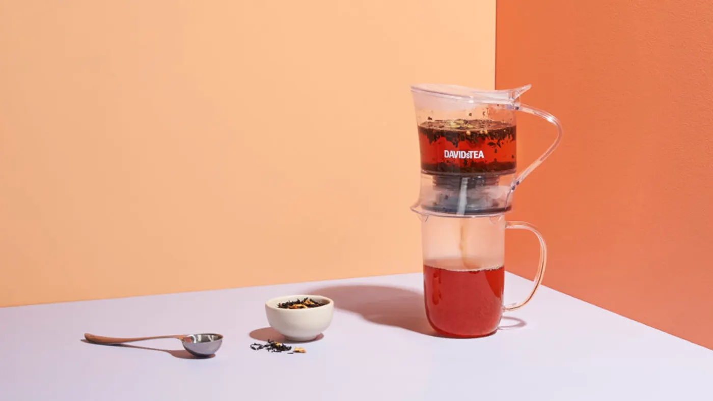 A tea brews on top of a purple countertop.