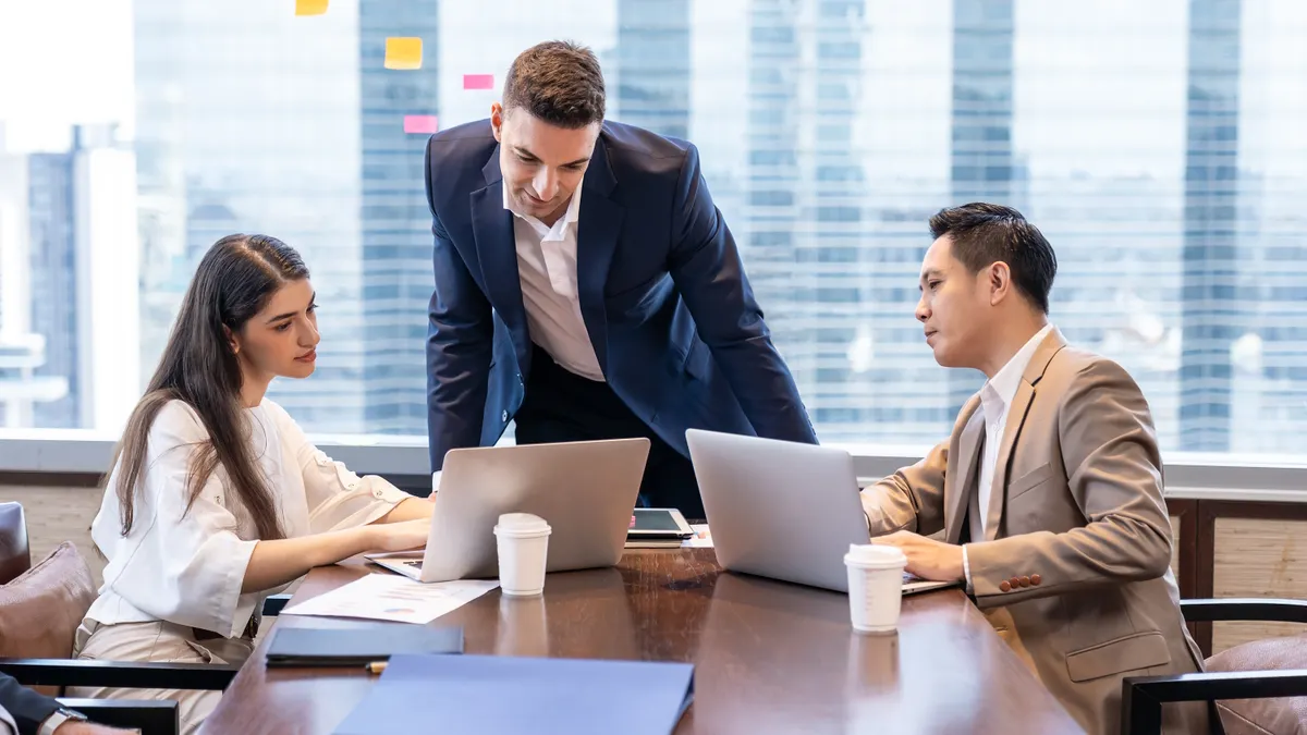 Businessman meeting and discussing to colleagues in the meeting room.