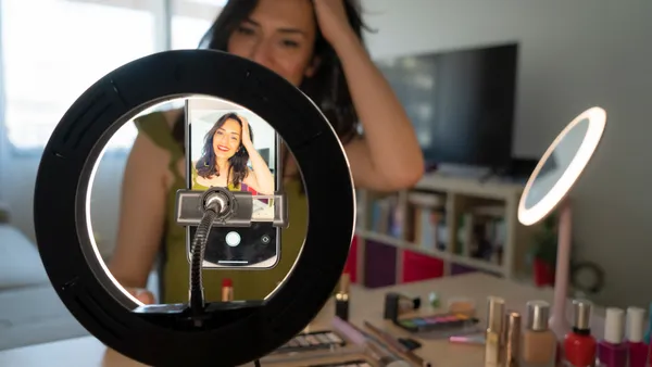 an influencer doing a make up tutorial on camera