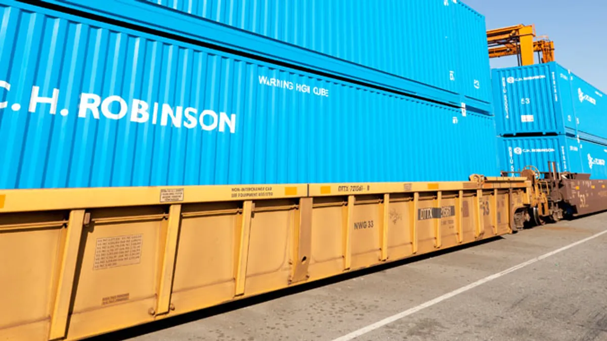 These are c.h. robinson containers on a rail line in what appears to be a port.