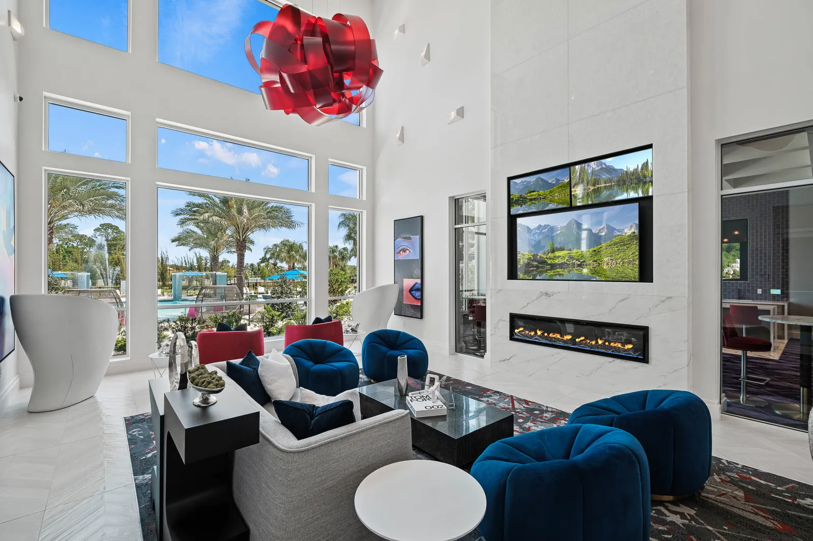 A lounge space with white walls, indoor fireplaces and couches.