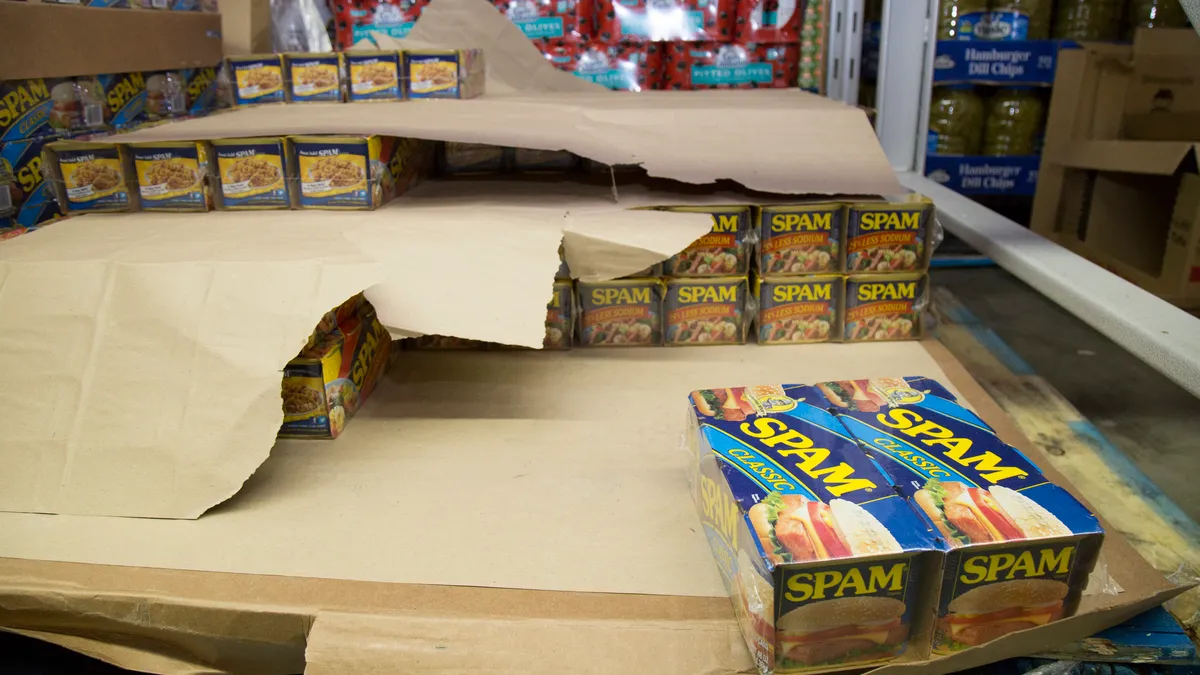 Cans of spam are seen at a wholesale grocery store.