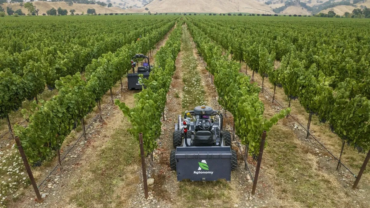 Tractors with the Agtonomy logo are seen in wine vineyards