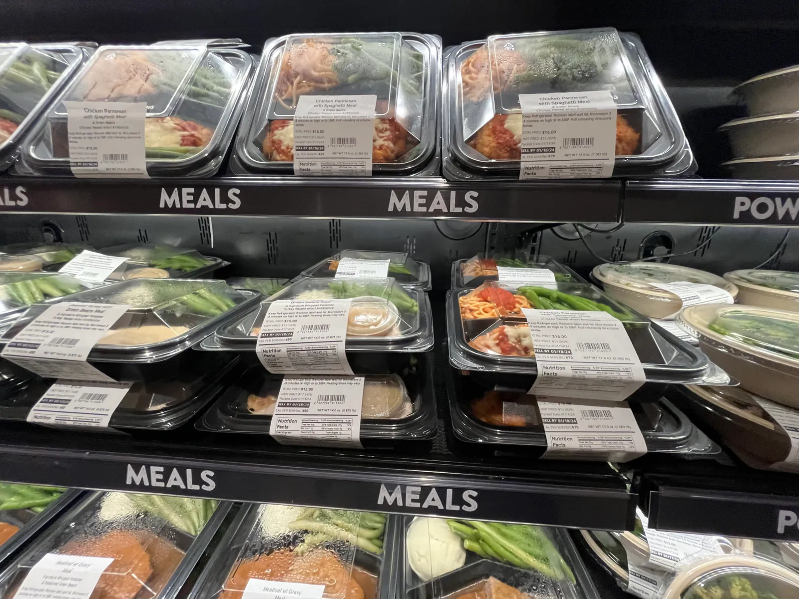 Close-up of packaged meals on grocery store shelves.