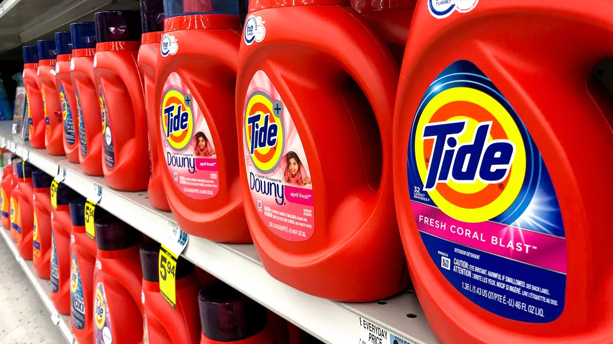 Rows of Tide detergent bottles on a store shelf