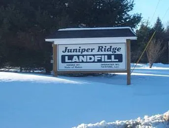 A snow-covered sign reads &quot;Juniper Ridge Landfill&quot;