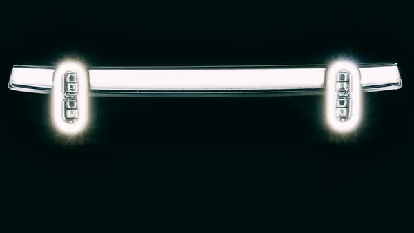 The front light bar of a Rivian electric vehicle showing the headlights on a black background.