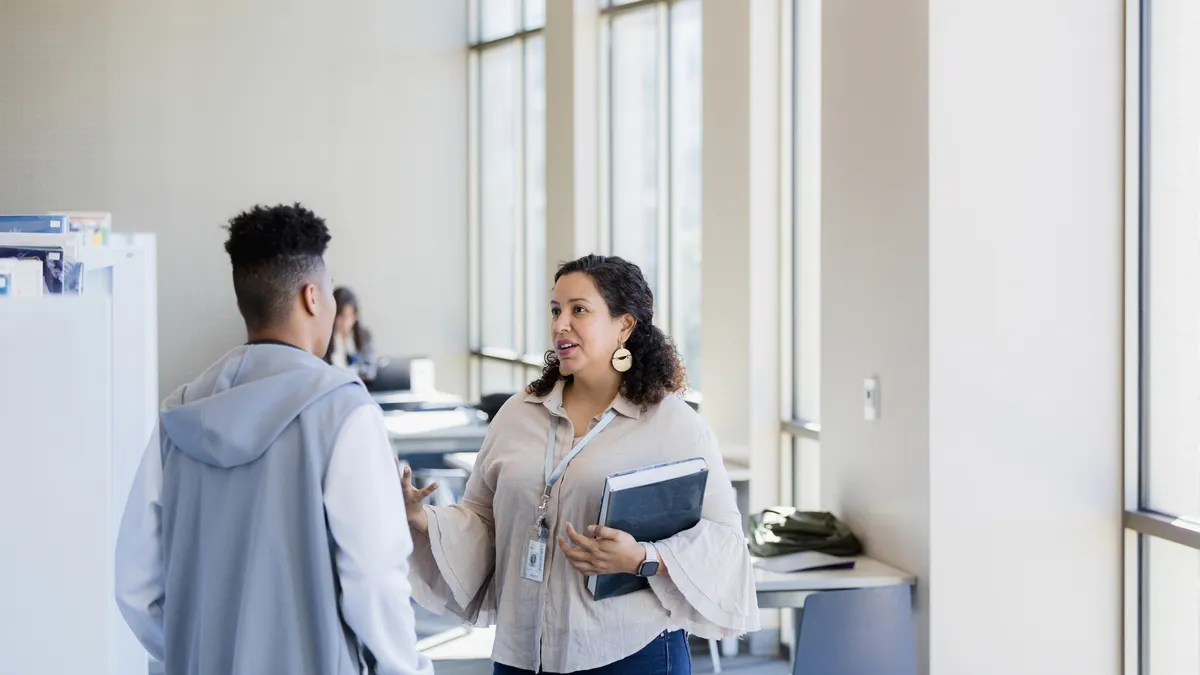 An adviser helps a college student