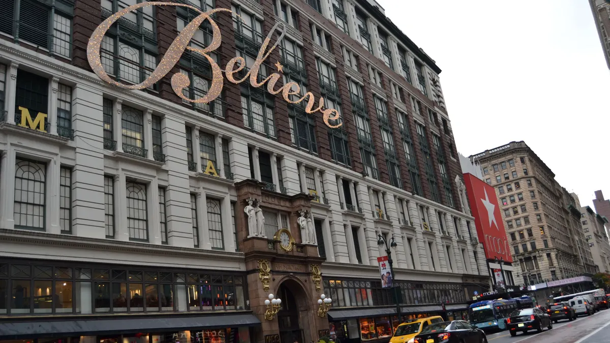 A Macy's building with the word "Believe" written on it in bright lights.