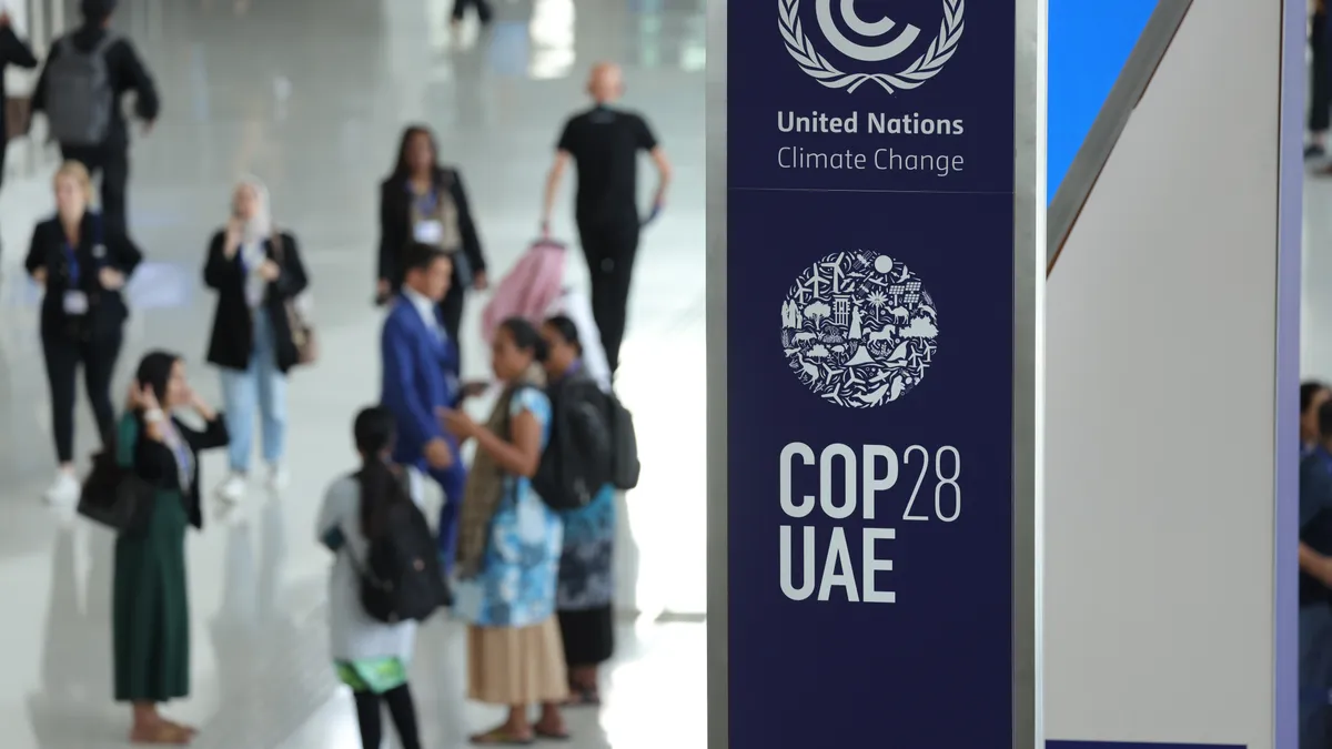 A banner hangs in a venue at the UNFCCC COP28 Climate Conference.