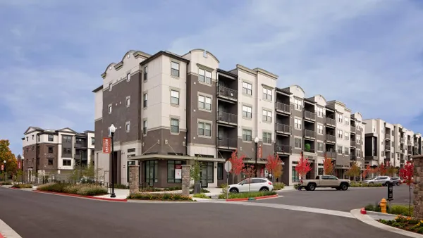 Multi-colored mid-rise mixed use property along a street