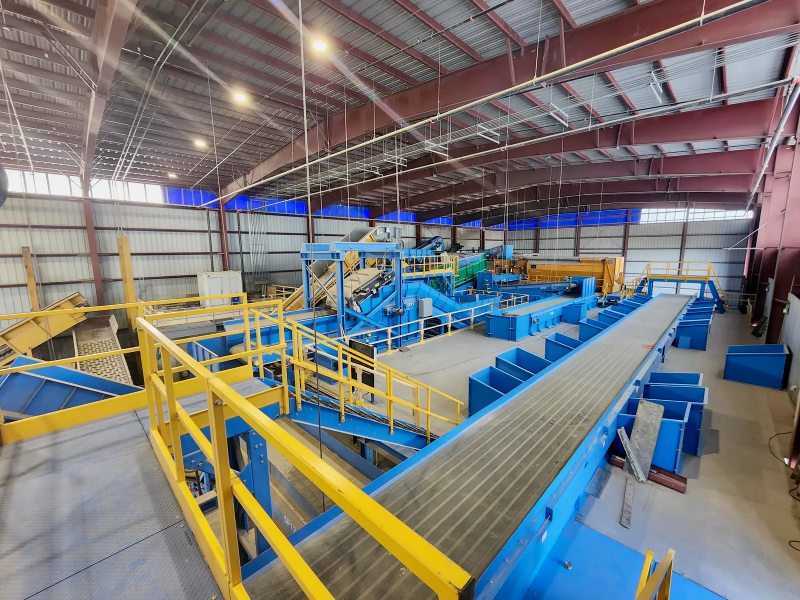 Industrial building with catwalks and sorting lines for recyclables