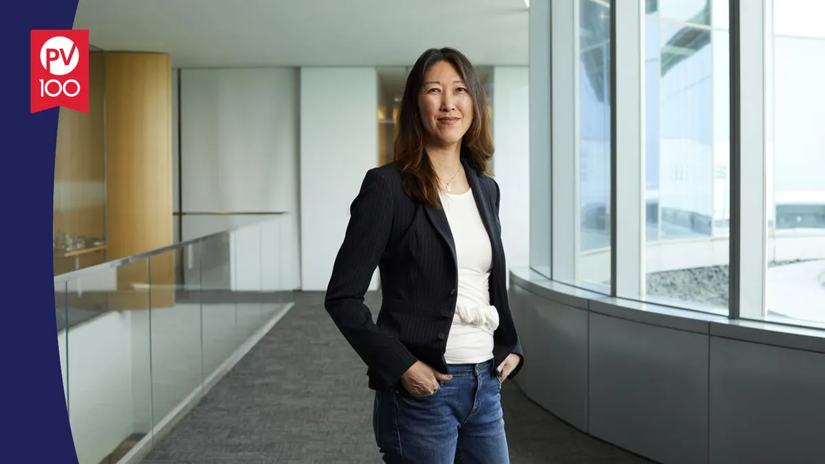 A portrait of Julie Kim framed with a banner icon that reads "PV 100"