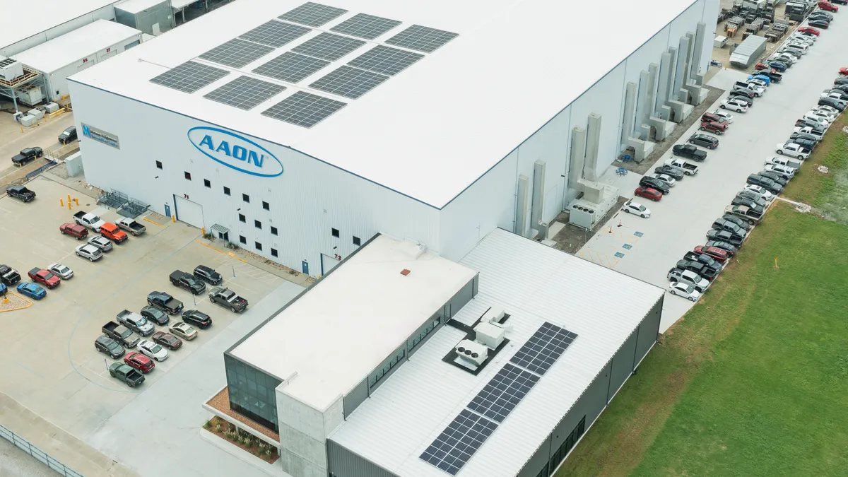 overhead view of solar panels on roof of AAON corporate headquarters and exploration center in Tulsa, Oklahoma. It's a large, flat-roofed building.