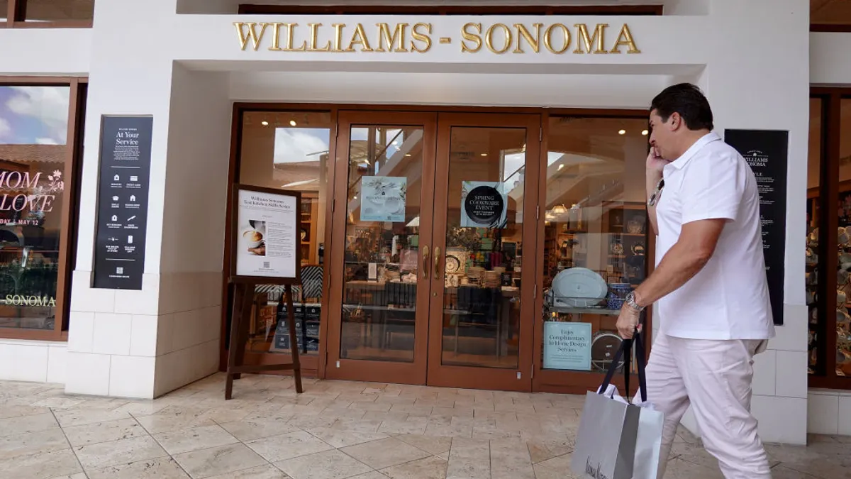 A Williams-Sonoma store with a customer walking by.
