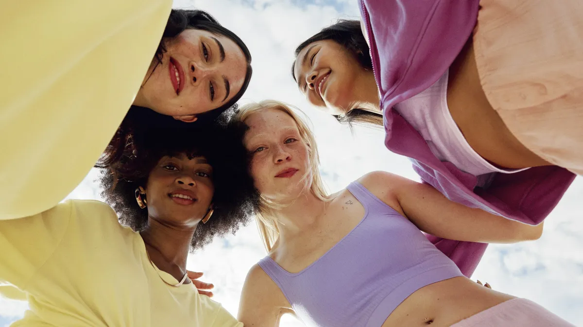 Four people standing in a circle wearing items from Florence by Mills Fashion