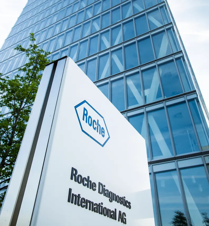 A Roche logo is seen on the side of a building.