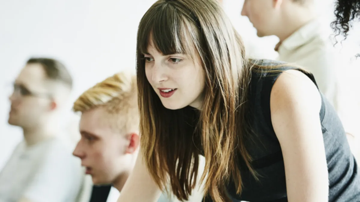 A woman looking at something at the office, Docusign.