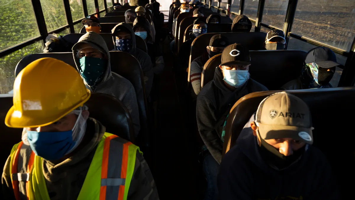 Farm laborers arrive for their shift at Fresh Harvest, one of the largest employers of people using the H-2A temporary agricultural worker visa.