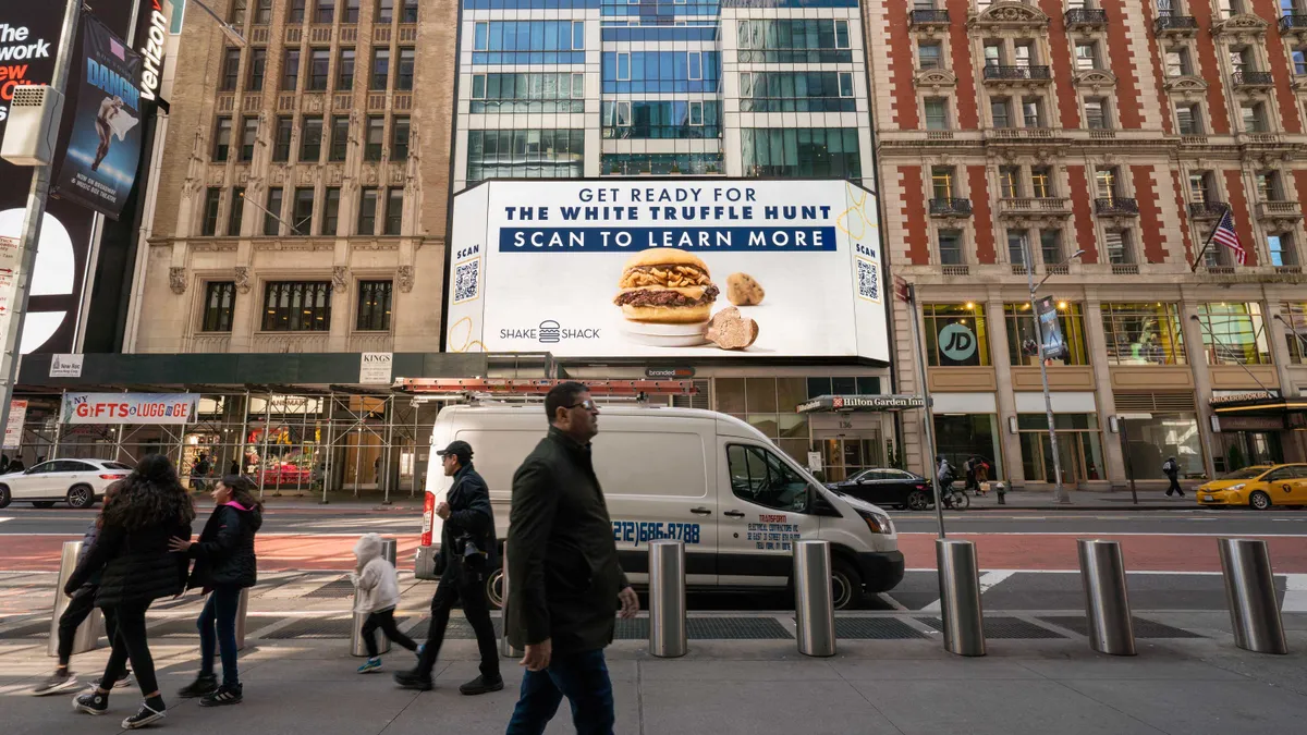 A digital billboard in New York City promoting Shake Shack's White Truffle Menu