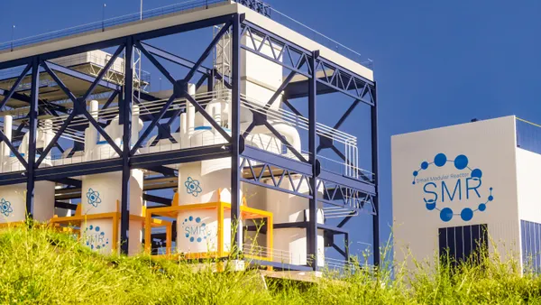 3D rendering of a small modular nuclear reactor power plant on a sunny day.