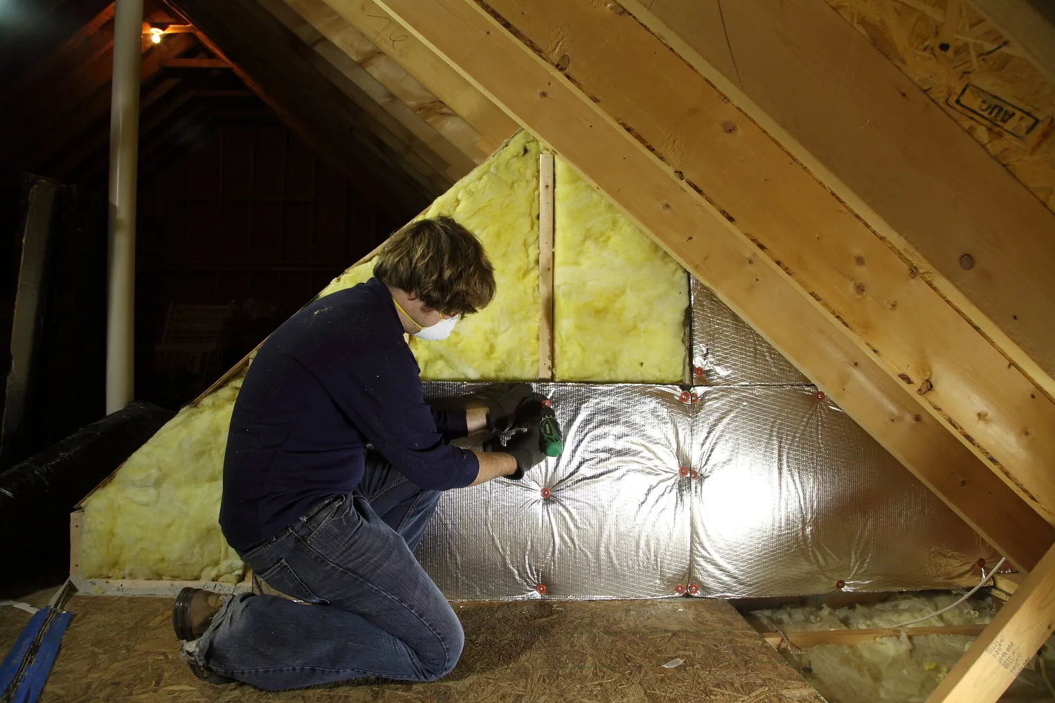 attic insulation being installed