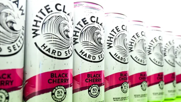 Cans of White Claw are displayed next to each other in a line.