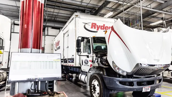 A truck's hood opened for maintenance.