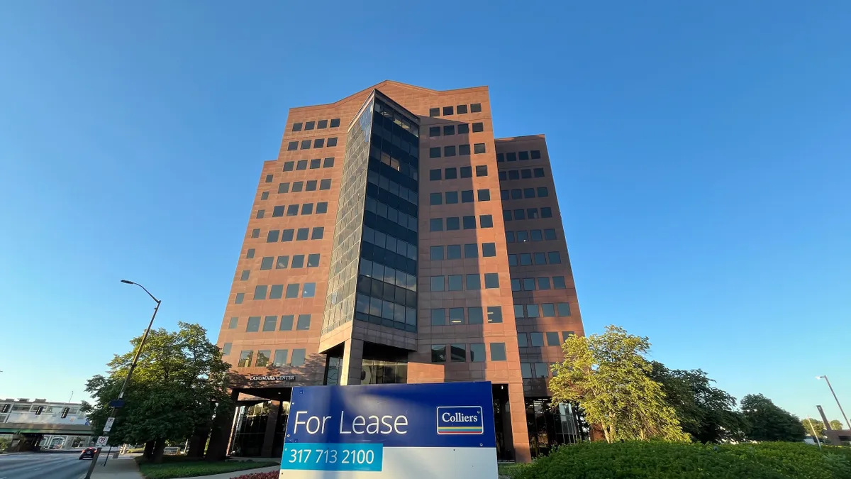 A Colliers' leasing sign outside of an office building.