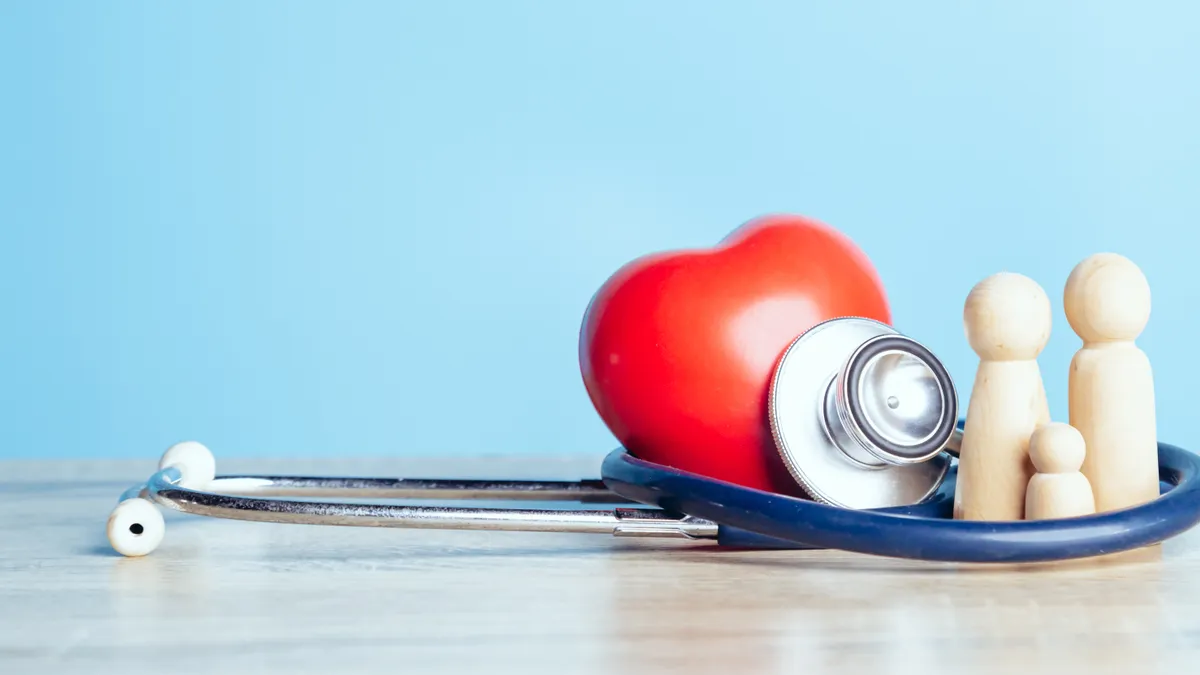 Family with stethoscope and a red heart. Concepts of a physical examination and Insurance family health live concept.