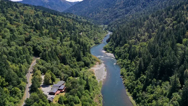 In an aerial view, the Klamath River flows by the Yurok Tribe tribal headquarters.
