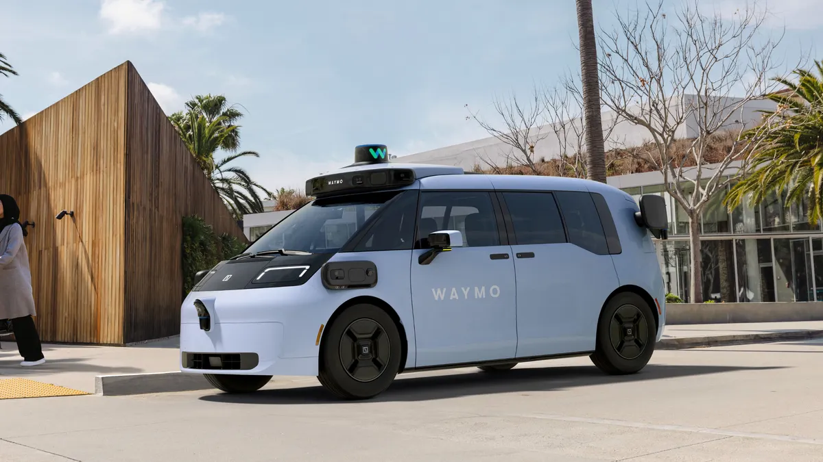 A blue Waymo autonomous passenger van designed in partnership with China-based electric automaker Zeekr.