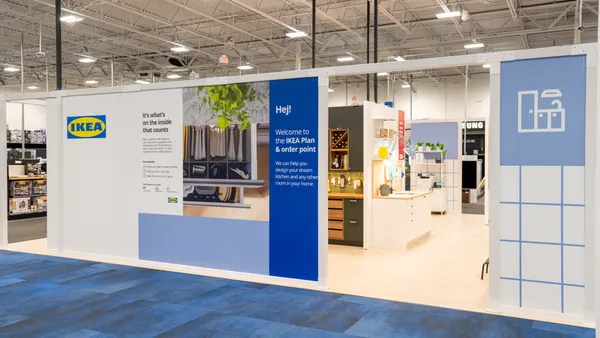 A blue and white Ikea shop-in-shop inside of a Best Buy storefront.