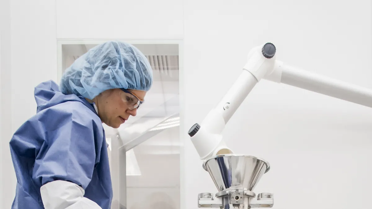 Woman in protective gear at a biomanufacturing lab