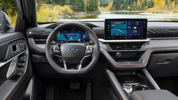 The interior of a 2025 Ford Explorer SUV showing the steering wheel, instrument cluster and center display screen.