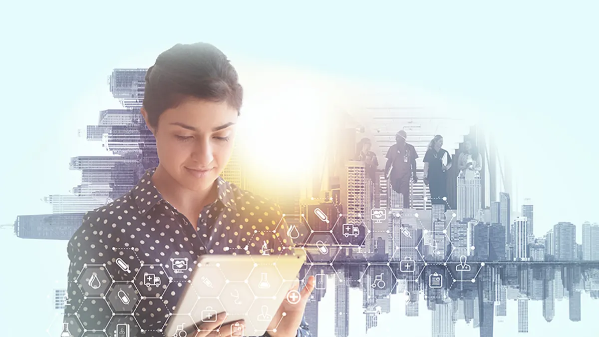 Peron looking at a tablet with a big city skyline view behind