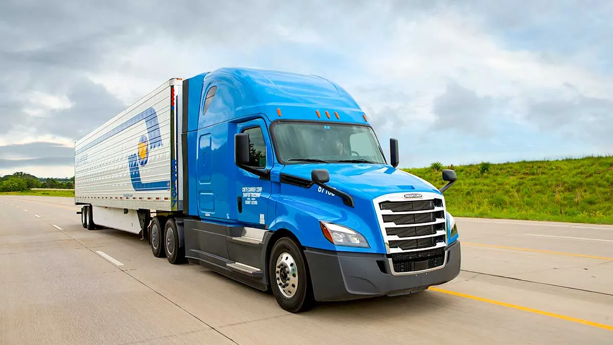 A Shaffer Trucking tractor trailer drives on the road.