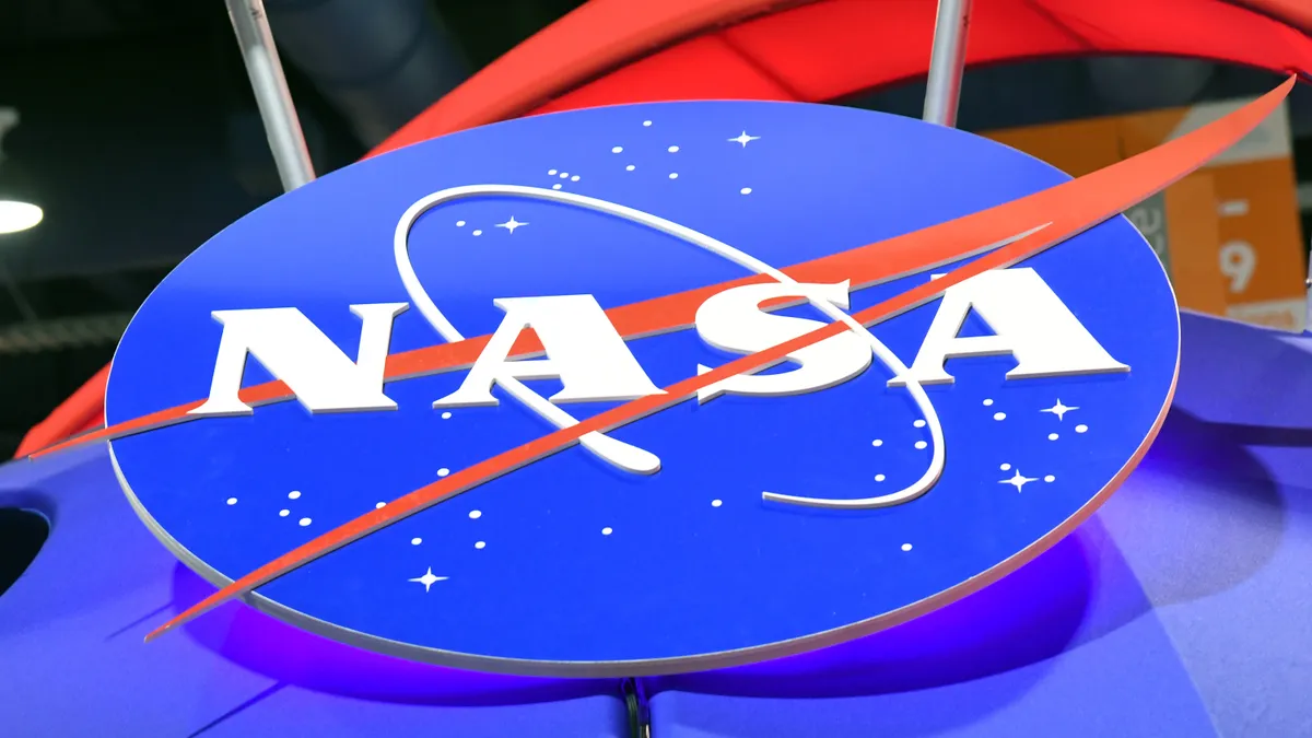 The NASA logo is displayed at a booth.