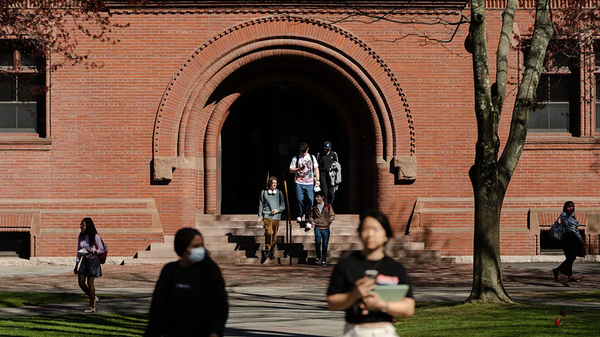 Students walk through the campus of Harvard University.
